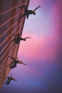 Aerial dancers on the side of a building
