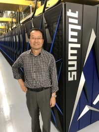 Picture of Yiqi Luo with supercomputer