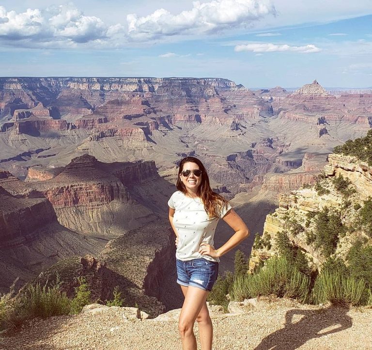 Graduate student standing in front of Grand Canyon view